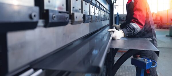 technician operating press brake
